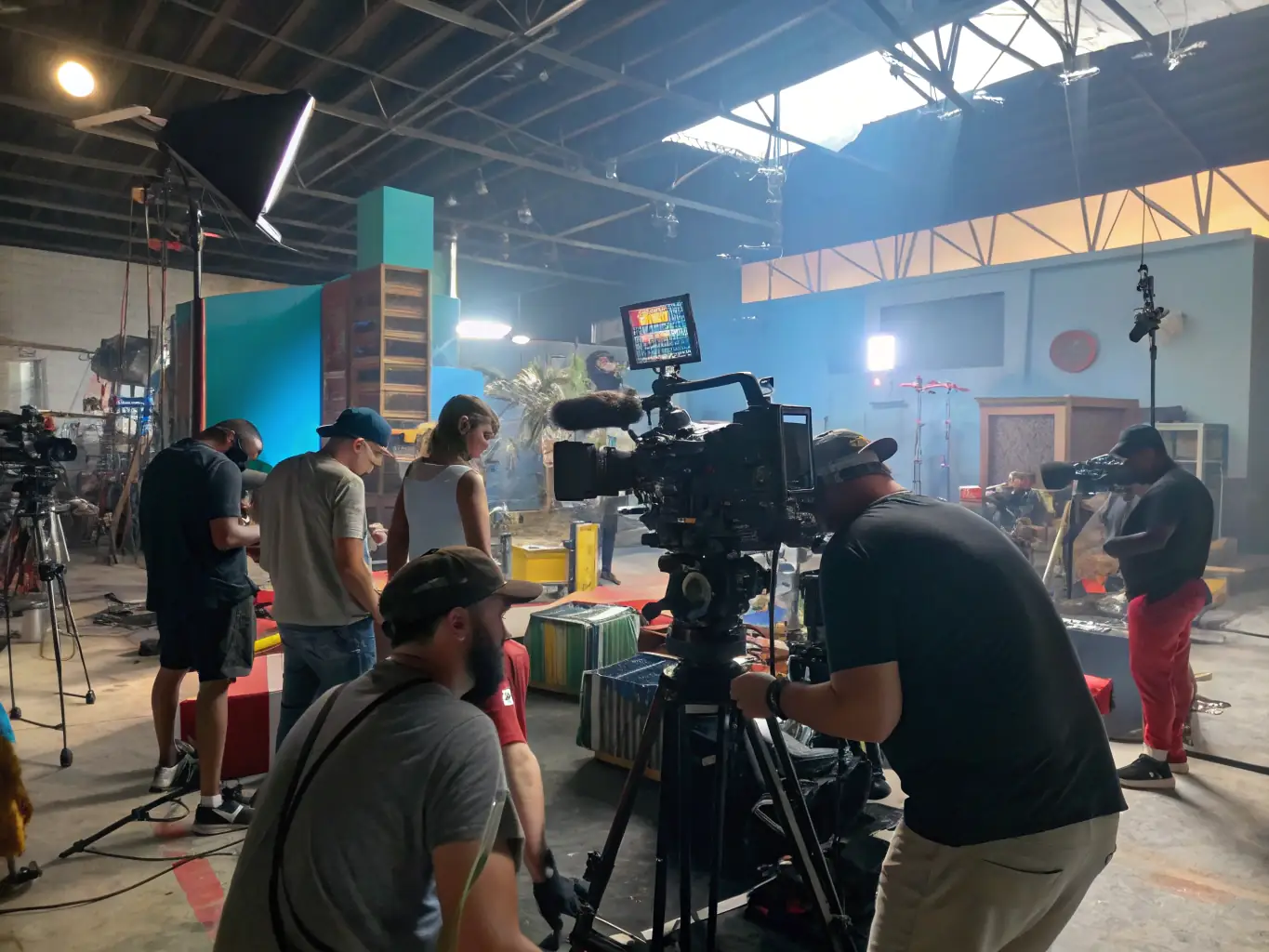 A dynamic shot of young filmmakers collaborating on a short film set, using professional equipment and displaying creative energy.