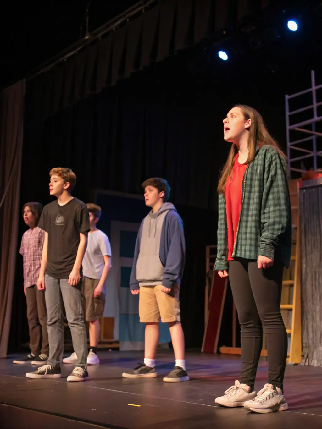 A group of young actors rehearsing a play, demonstrating the agency's commitment to theater and performing arts education.