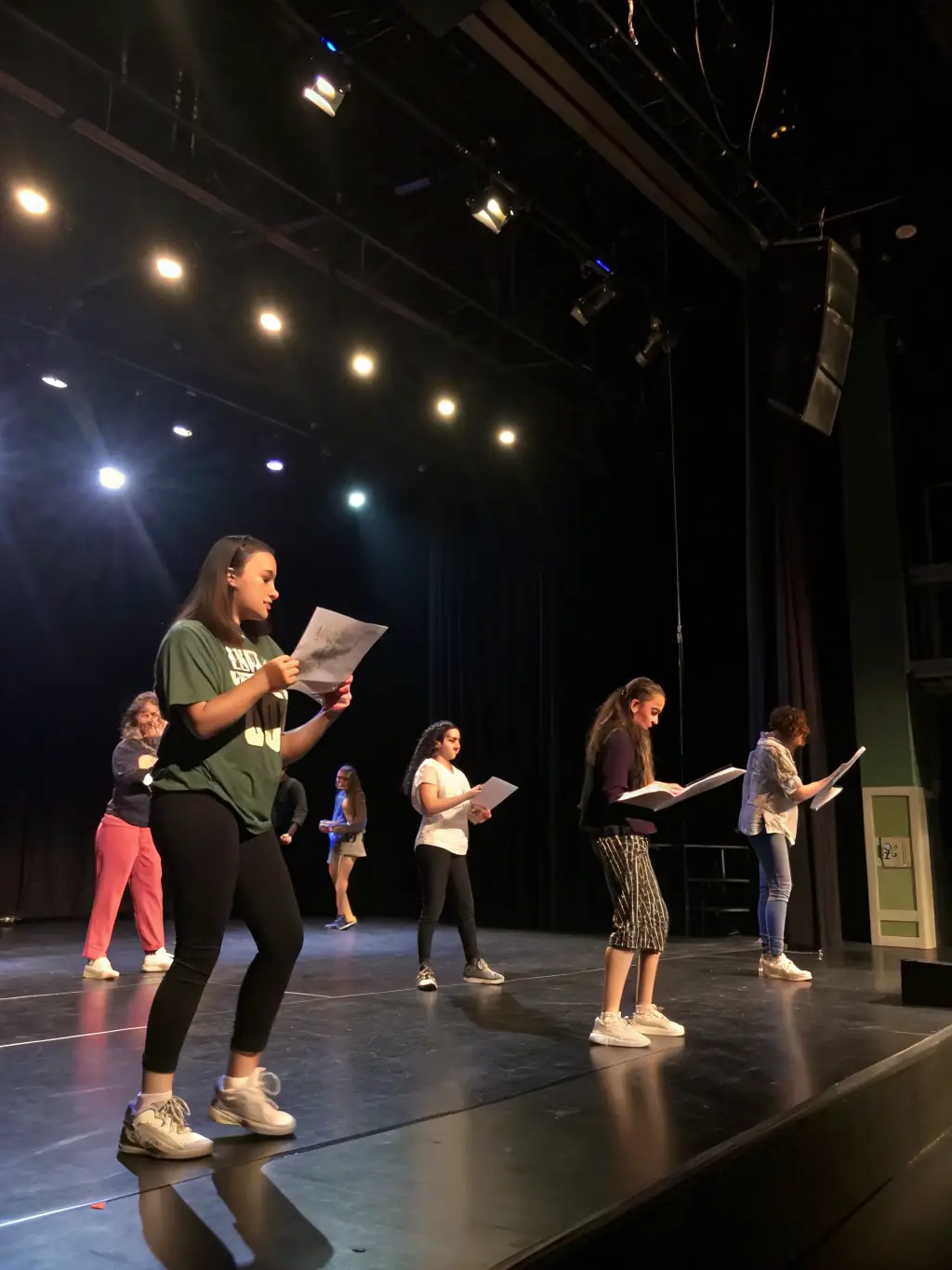 A vibrant image showcasing young actors participating in a theater workshop, focusing on stage presence and character development, set in a community arts center.